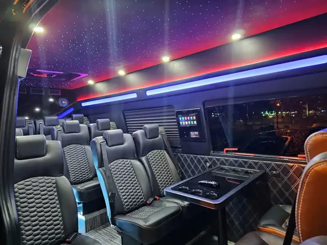 Executive Sprinter with starlight ceiling, red and blue LED strips and leather seating around a table — Sprinter service in SoHo