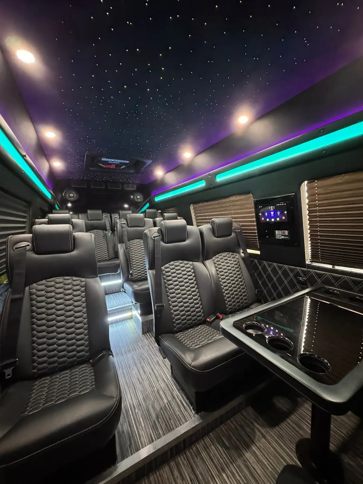 Executive Sprinter cabin with starlit headliner, teal accent lighting and rows of leather seats — Manhattan to Washington, DC transfers