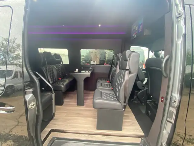 Executive Sprinter interior seen through the open door, with leather seating and a purple ceiling glow — Cruise Terminal Transportation NYC