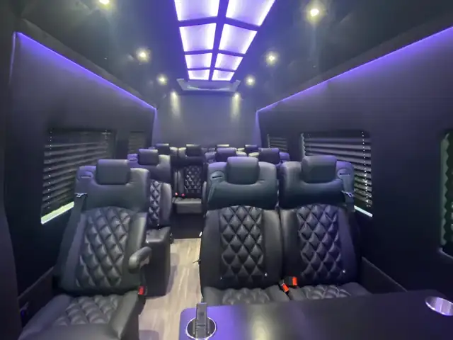 Executive Sprinter cabin with a lit ceiling panel and purple accent lighting above leather seats — TEB to Midtown Manhattan transfers