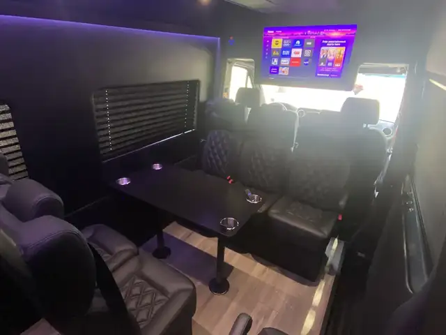 Executive Sprinter with a front TV, leather seats and purple lighting over the ceiling — Sprinter Service Newark — Mercedes-Benz