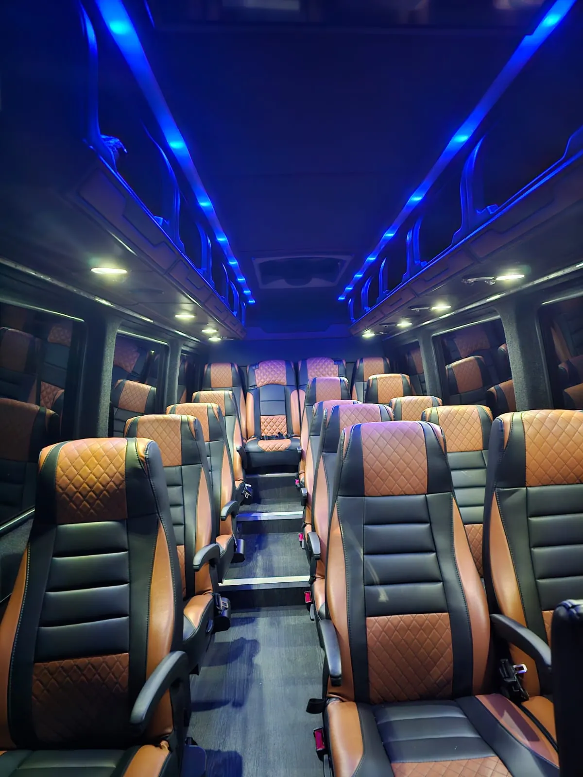 Executive Sprinter with black and tan leather seats in long rows under blue ceiling lights — Manhattan to Foxwoods / Mohegan Sun, CT transfers