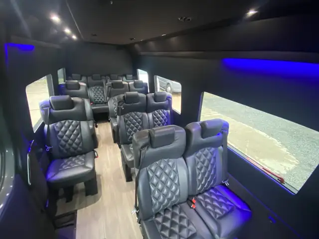Executive Sprinter with blue accent lighting and diamond leather seats opposite a wide window — NYC Sprinter service areas
