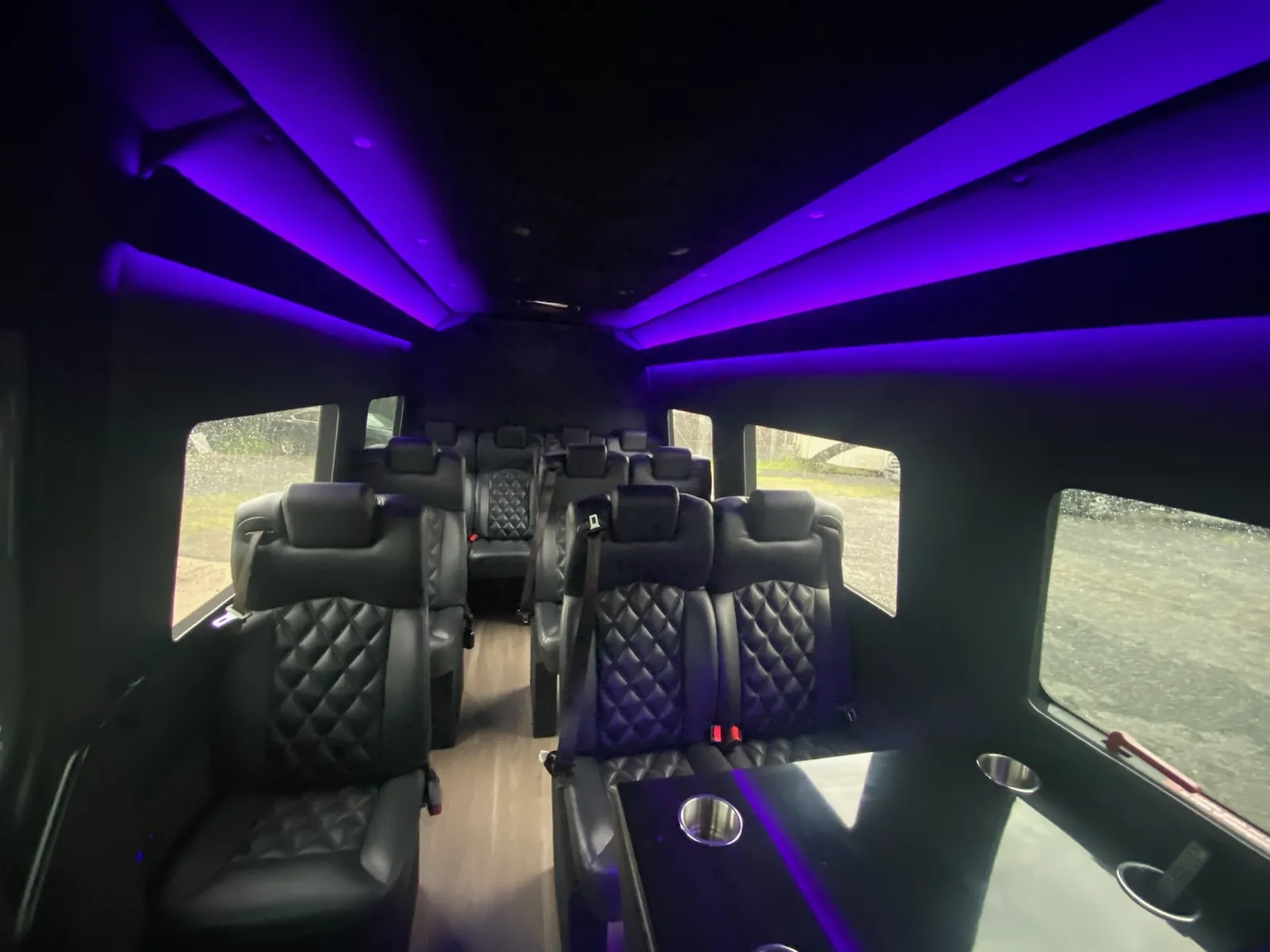 Executive Sprinter with violet ceiling glow and leather seats leading toward the rear — Wine Tours