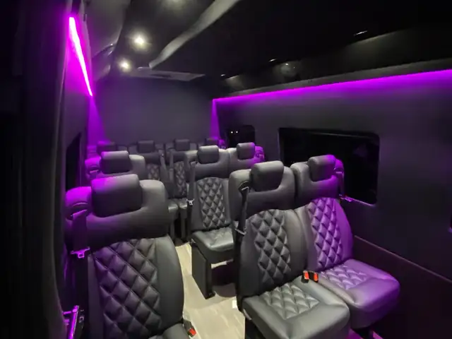 Executive Sprinter with magenta side lighting, rows of leather seats and a wood-look floor — About Mercedes Sprinter NYC