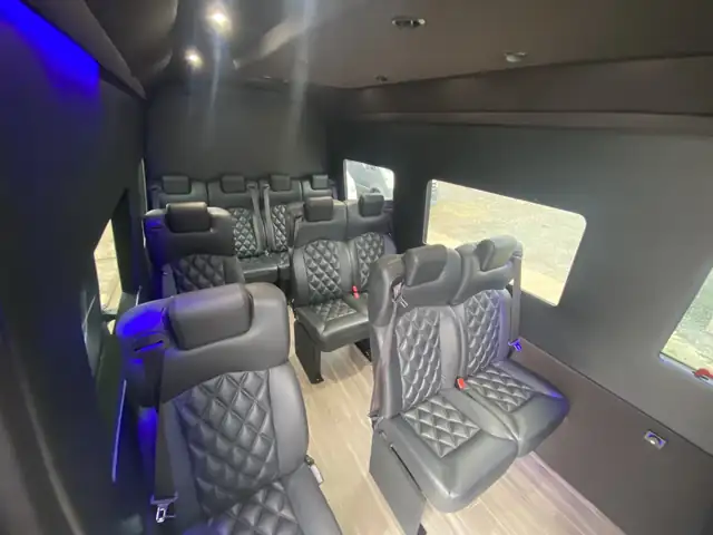 Executive Sprinter with blue LED trim and leather seats angled toward a bright side window — Manhattan to Philadelphia, PA transfers