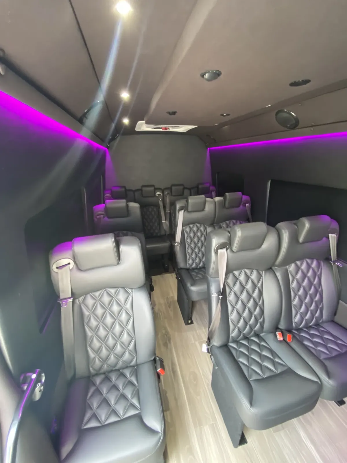 Executive Sprinter with magenta accent lighting and gray leather seats along a light wood floor — Sprinter service in Upper West Side