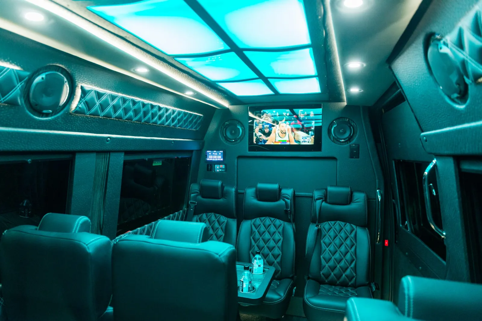 Executive Sprinter finished in teal with a lit skylight panel, quilted walls and a wall-mounted TV — Sprinter Service Newark — Mercedes-Benz