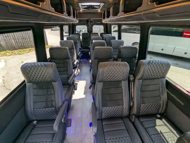 Executive Sprinter with high-back gray leather seats in rows and a wide aisle — Van for Hire NYC: 12–15 Passenger Mercedes Sprinter