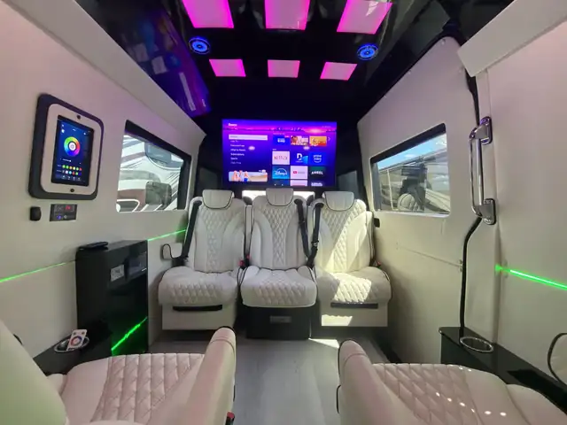 Jet Sprinter with white leather captain chairs, a large wall TV and pink LED ceiling panels, Mercedes Sprinter NYC