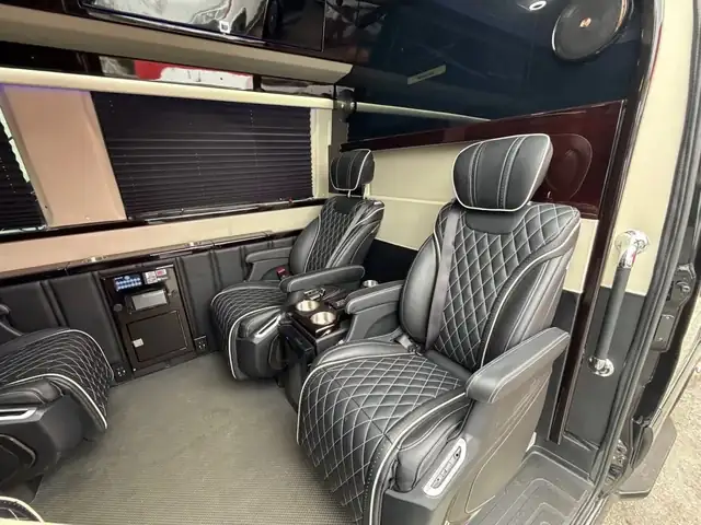 Jet Sprinter with black diamond-stitched captain chairs, side cabinetry and a bar cabinet — MetLife Stadium & Event Shuttle