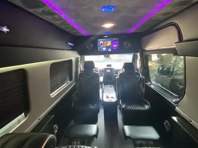 Jet Sprinter with black leather seats, a dark starlit ceiling and a TV toward the front — Sprinter service in Midtown Manhattan