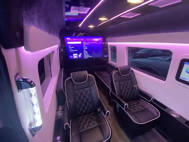 Jet Sprinter with a large wall TV, black diamond captain chairs and pink LED trim — LGA airport group transfers