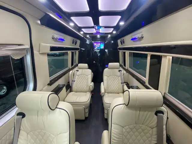 Jet Sprinter with cream leather captain chairs down both sides, panel skylights and dark floor — TEB to Midtown Manhattan transfers