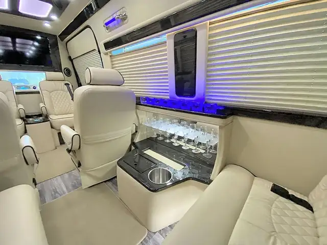 Jet Sprinter with cream leather seats and a built-in bar with glassware and a cup holder — TEB airport group transfers
