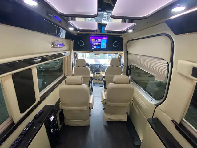 Jet Sprinter with cream leather chairs and side benches under skylight-style ceiling panels — Sprinter service in Hudson Yards