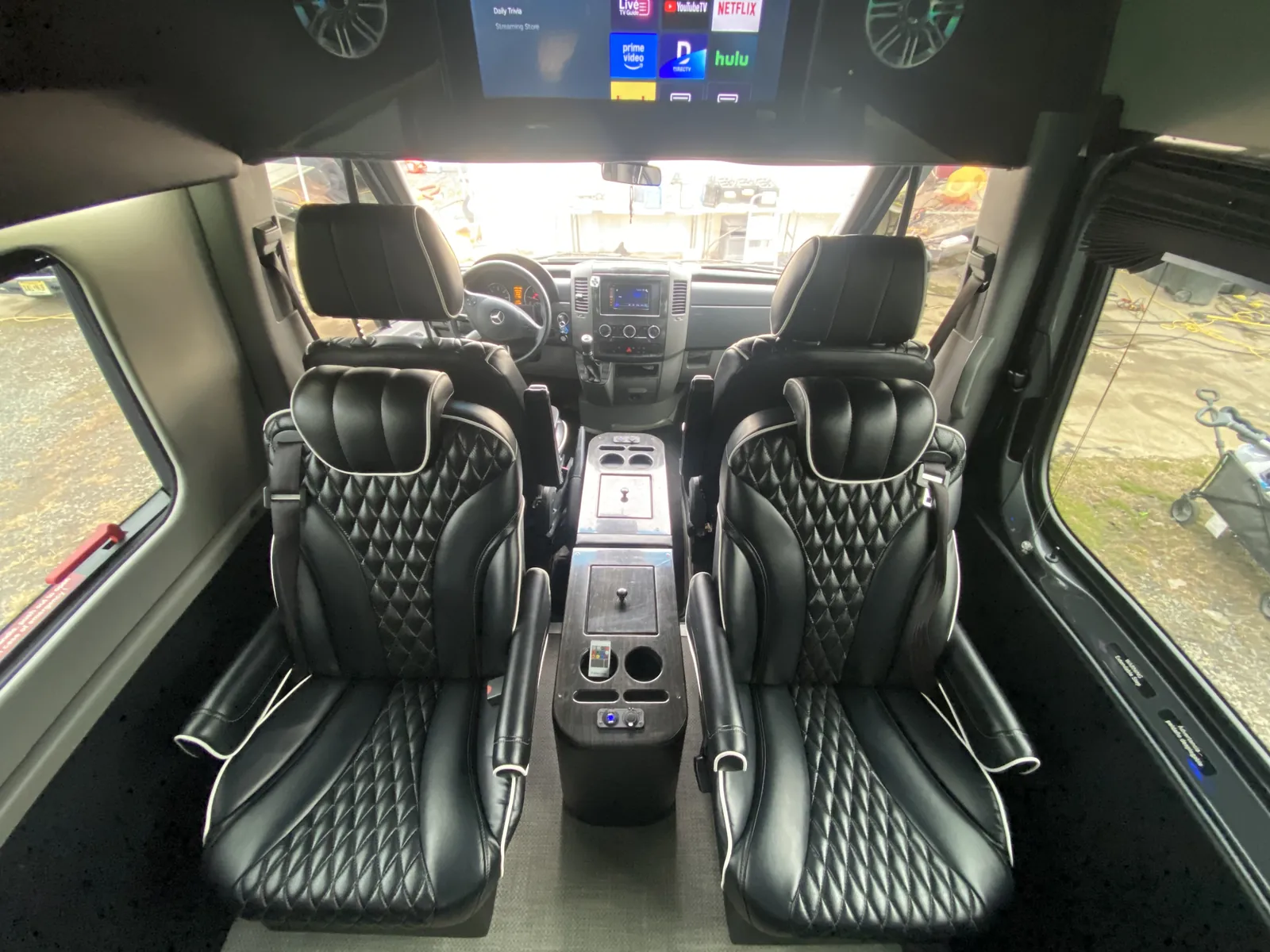 Jet Sprinter with two black diamond captain chairs, a center console and an overhead TV — JFK vs LGA vs EWR: Which NYC Airport Should Your Group Fly Into?
