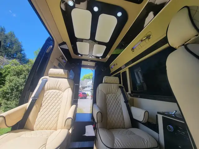 Jet Sprinter with cream diamond-stitched captain chairs under ceiling skylight panels on a sunny day — NYC Sprinter guides