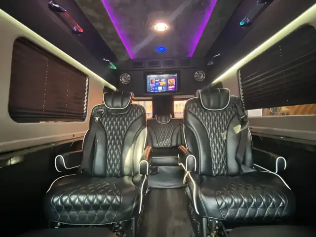 Jet Sprinter with black quilted captain chairs, dark wood floor and a purple ceiling glow — Sprinter Service Newark — Mercedes-Benz
