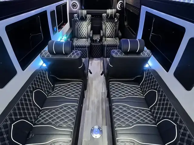 Jet Sprinter with a blue lit ceiling, diamond-stitched black leather benches and a rear bar area — NYC airport transfers