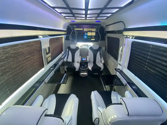 Jet Sprinter with white and black recliners, a ceiling light grid and a stone-look accent wall — Sprinter service in Chelsea