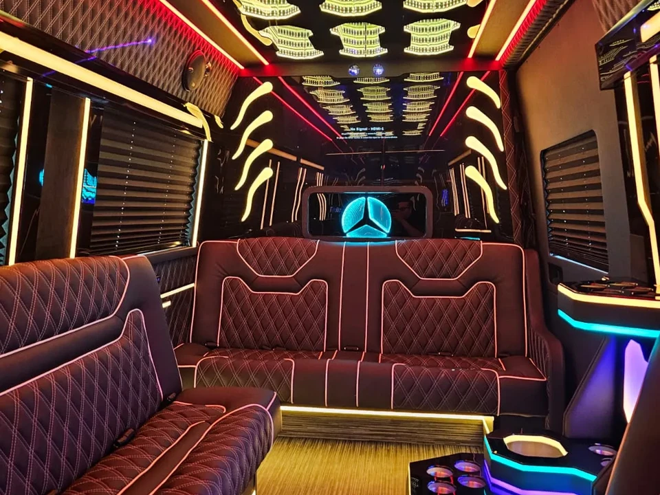 Limo Sprinter with a red-edged burgundy leather sofa and a yellow-lit sculpted ceiling, Mercedes Sprinter NYC