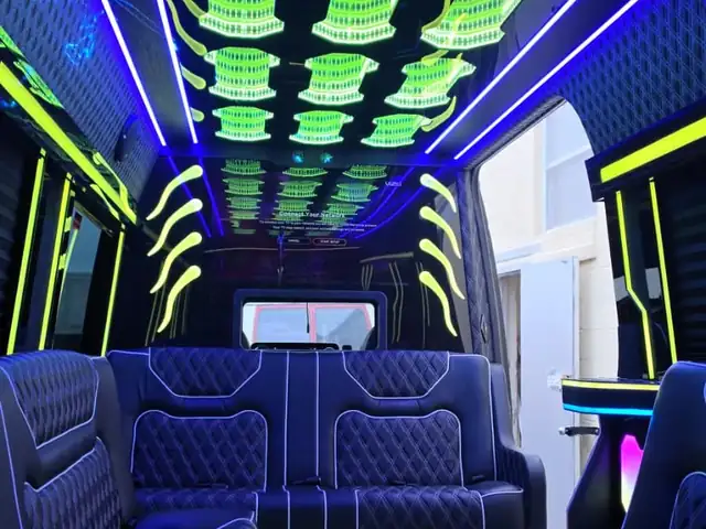 Limo Sprinter with blue leather lounge seating and a green sculpted LED ceiling, Mercedes Sprinter NYC