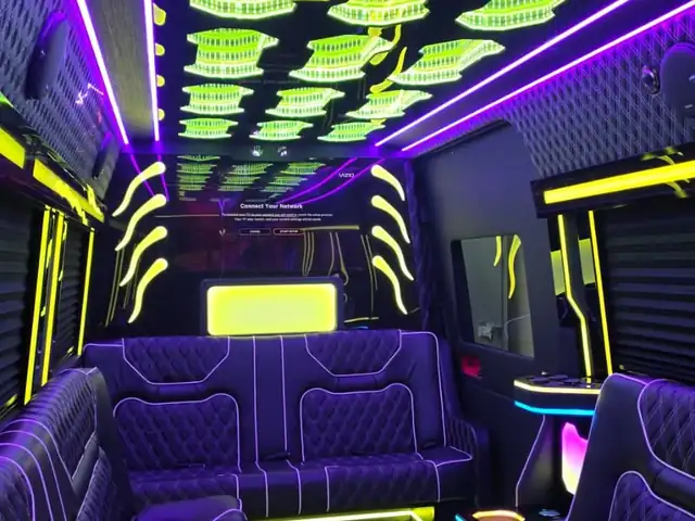 Limo Sprinter party cabin with purple and blue lights, a green ceiling display and a rear TV, Mercedes Sprinter NYC