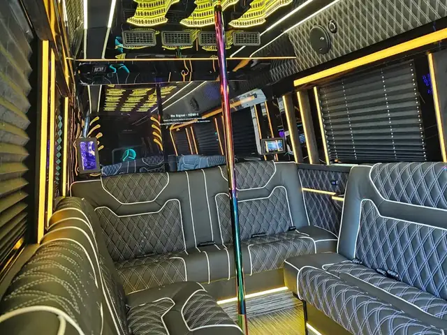 Limo Sprinter with charcoal contour-stitched sofas, a dance pole and warm yellow trim lighting — Wedding Shuttle Service New Jersey — Mercedes Sprinter