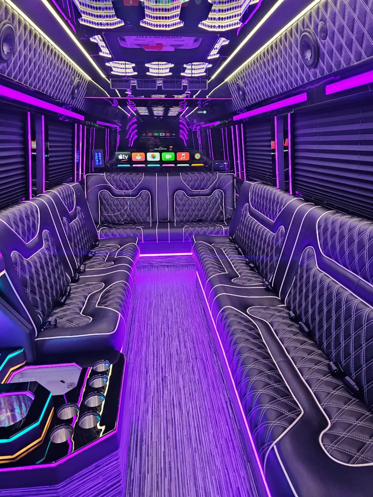 Limo Sprinter with a purple lit aisle, tufted black sofas and a rear bar with cup holders — Wedding Shuttle Service Long Island — Mercedes Sprinter