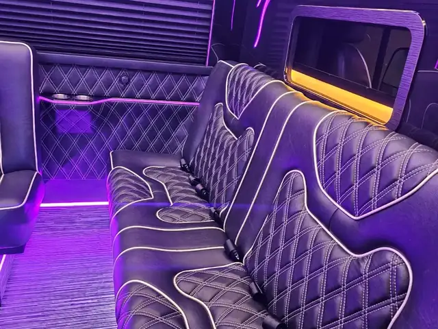 Limo Sprinter with violet-lit tufted sofas, a wall TV and window shades — Wedding Shuttle Service Long Island — Mercedes Sprinter
