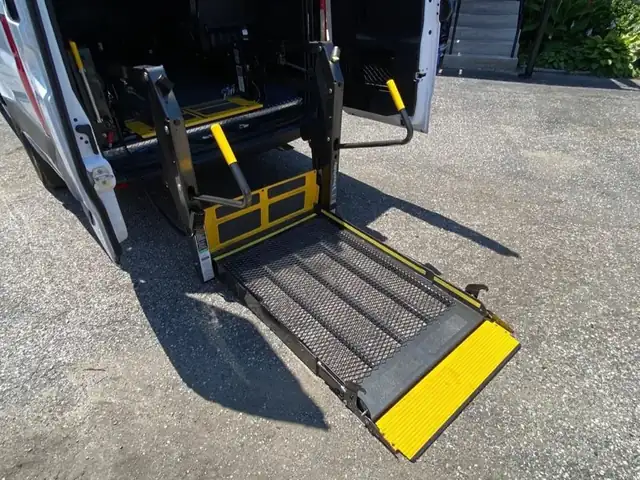 Wheelchair accessible Sprinter with the yellow-edged rear platform lift lowered to the pavement, Mercedes Sprinter NYC