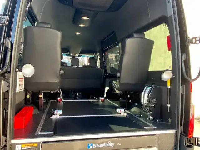 Wheelchair accessible Sprinter rear doors open on a flat cargo floor with folding seats, Mercedes Sprinter NYC